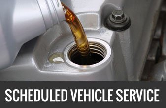 a car has its oil refilled during a scheduled service
